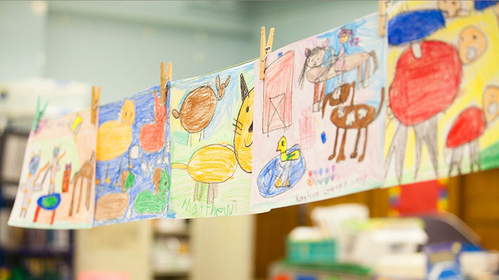 kid drawings are hangings on a string.
