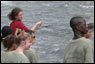 A teacher pointing out areas of interest to their class.
