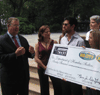 Commissioner Hess speaks with attendees of an August 21 press conference, announcing the donation of 800 school uniform vouchers to families with children in shelter