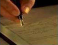 image of pen in hand
