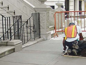 Repair man working on sidewalk