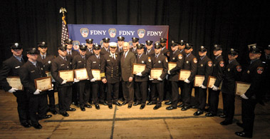 Fire Commissioner Nicholas Scoppetta and Chief of Department Salvatore Cassano join 23 probationary firefighters who served in the military. The firefighters graduated from the Academy on February 22.
