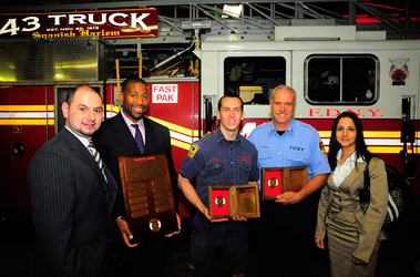 Members of Ladder 43 receive the Firemark Award for Heroism from Liberty Mutual. (L to R) Jonathan Vinokur, Liberty Mutual Sales Representative; Roger Edmond, Liberty Mutual Sales Representative; Firefighter John Haseney; Lt. Gregory Prial; and Rose Singh, Liberty Mutual Midtown Branch Manager.
