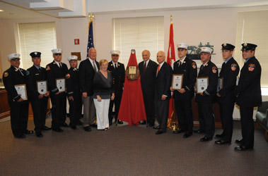 Fire Commissioner Nicholas Scoppetta, Chief of Department Salvatore Cassano, Thomas and Margaret Brick (fifth and sixth from the left) and Salvatore Bommarito (fifth from the right) join the eight 2009 Thomas Brick Scholarship winners.