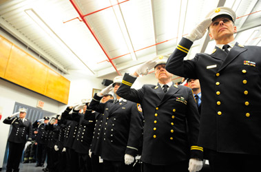 Two deputy assistant chiefs, six captains and 15 lieutenants were promoted during a promotions ceremony on Dec. 30. (R to L) DAC John Mooney, DAC Kevin Butler, Capt. Keith Faccilonga and Capt. John O'Connor prepare to receive their new ranks.