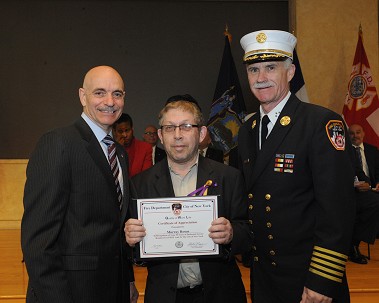 Fire Commissioner Salvatore Cassano and Chief of Department Edward Kilduff honor Murray Brown, who is celebrating 50 years with the FDNY.