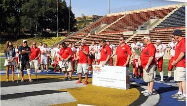 The check was presented to the families of the Granite Mountain Hotshots families after a football game between the Bravest FDNY Football Club and the California Blue Knights.