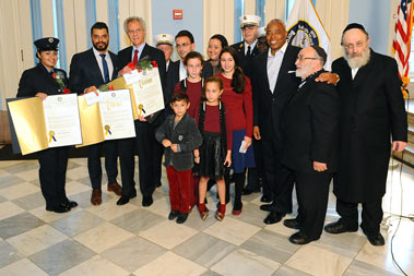 The three Heroes of the Month and Brooklyn Borough President Eric Adams with the Pfeiffer family