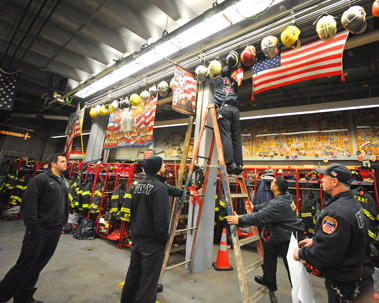 Firefighters hang the banners at the firehouse.