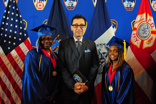 Fire Commissioner Daniel A. Nigro with class Valedictorian Iyana Curtis (right) and Salutatorian India Glover (left)