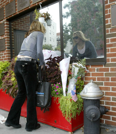 Firefighters, neighbors and friends mourn the loss of Firefighters Joseph Graffagnino and Robert Beddia at Engine Company 24/Ladder Company 5. The firefighters lost their lives in a seven-alarm fire on August 18. Photo courtesy of G.N.Miller/NY Post