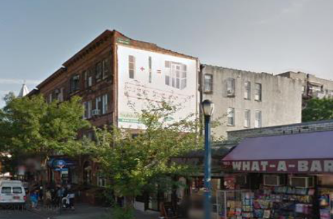 Photo of a buildings with illegal outdoor advertising sign.