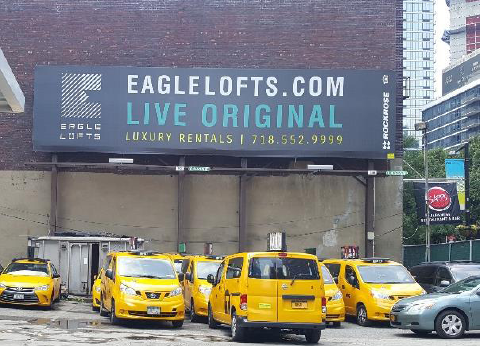 Photo of a buildings with illegal outdoor advertising sign.