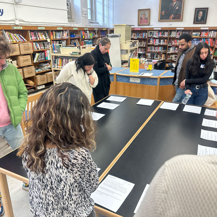 people gather around at a table.