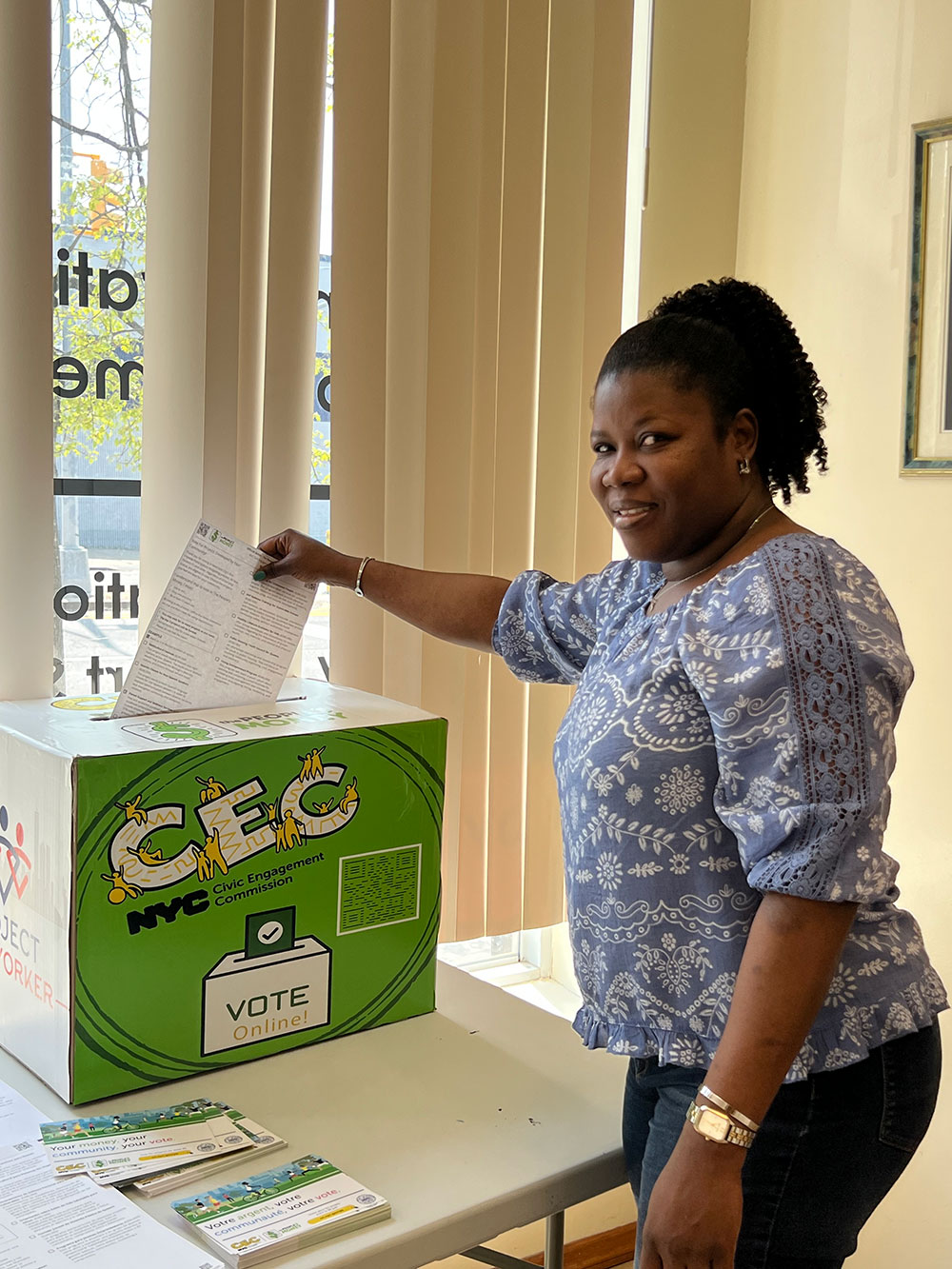 Woman putting ballot in voting booth