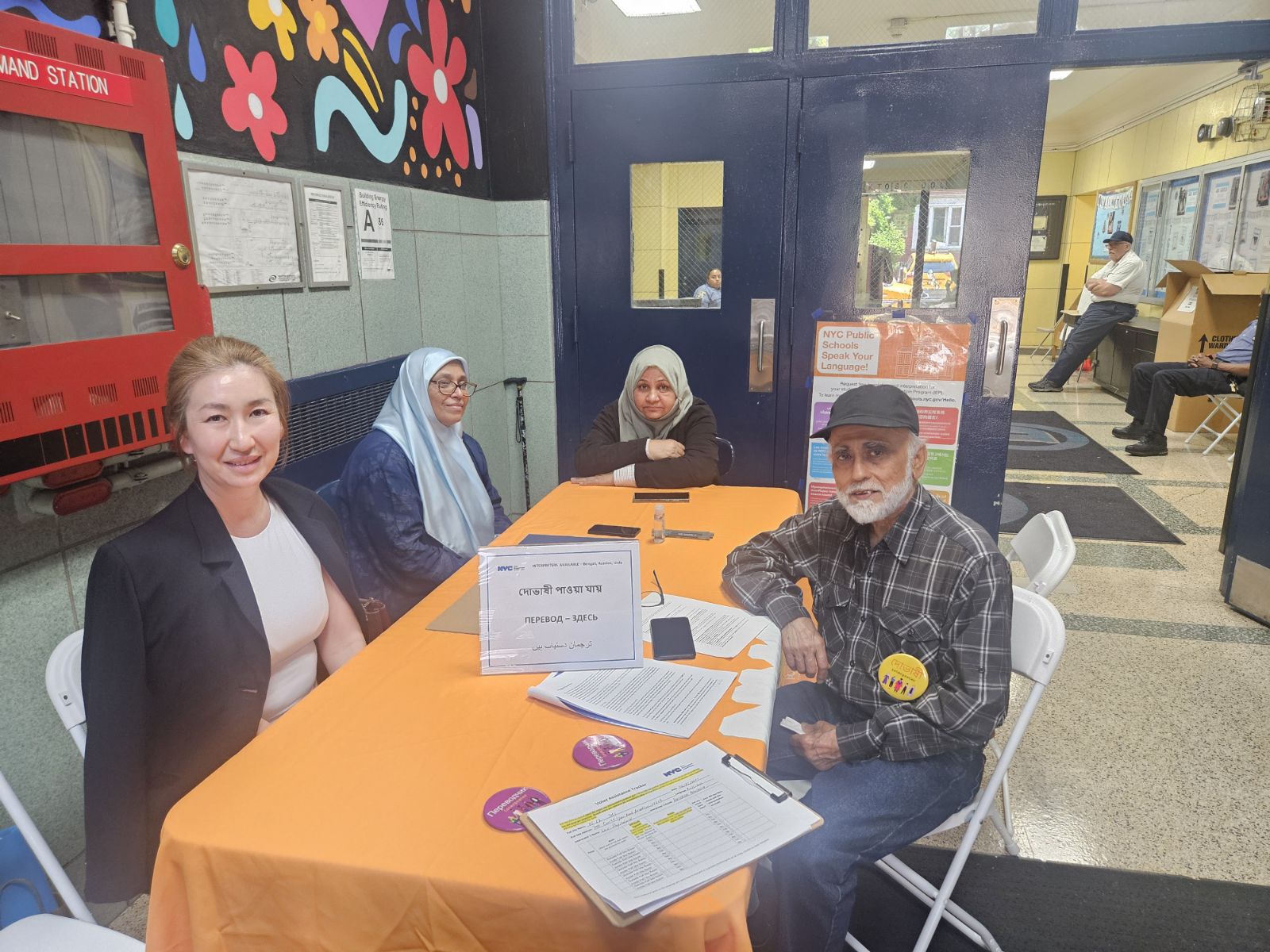 Voter Language Assistance table with four people