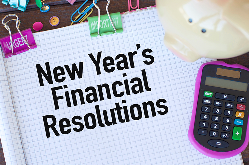 New Year's Financial Resolutions text written in a notebook on a desk
                                           