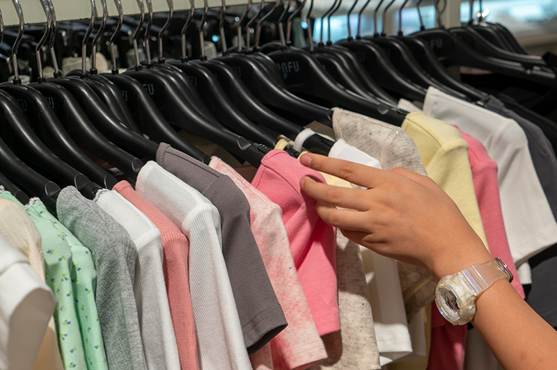 Clothing rack of shirts at a retail store.
                                           