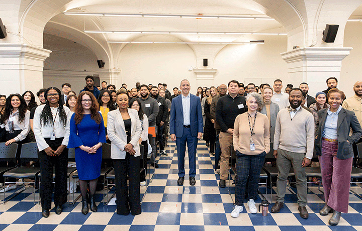 Commissioner Molina center aisle surrounded by senior agency staff and fellows in the mezzanine at One Centre Street.
                                           