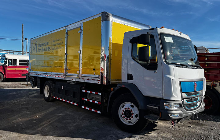 Yellow and white electric Materials for the Arts box truck with side guards.
                                           