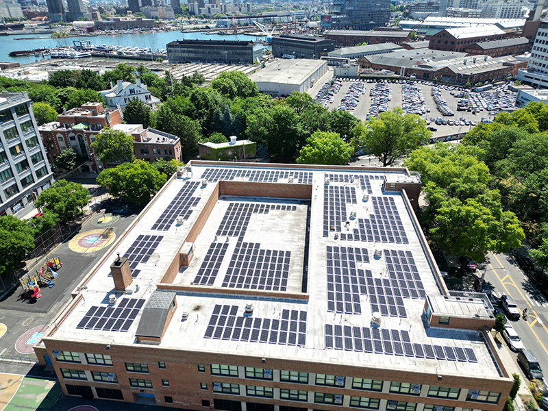 Drone shot of newly installed solar panels on a school roof.