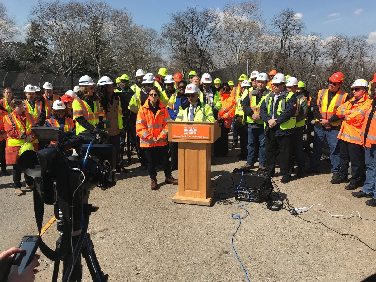 workings in hard hats and yellow and oranges jackets 