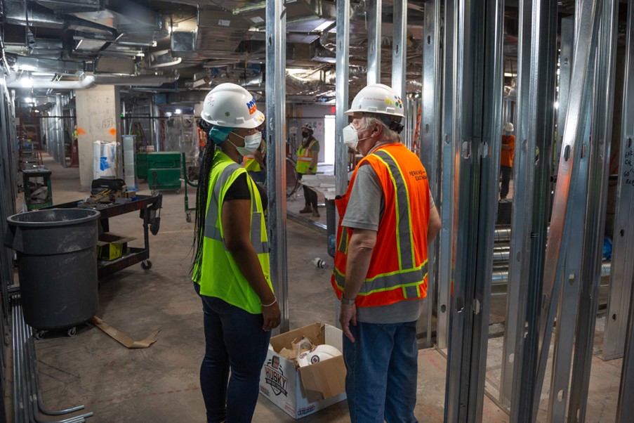 Jade Bailey on site at COVID Center for Excellence chatting with a construction worker