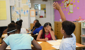 image of boy raising hand in class