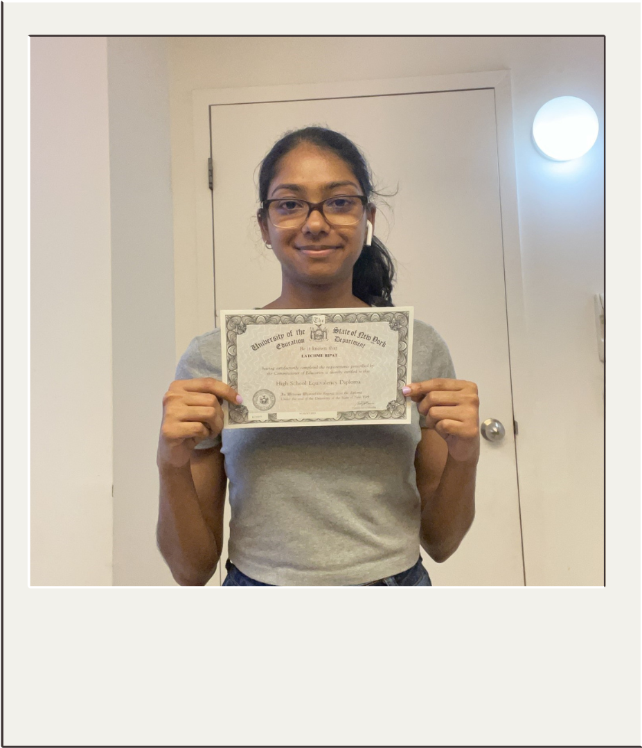 Latchme showing her diploma.