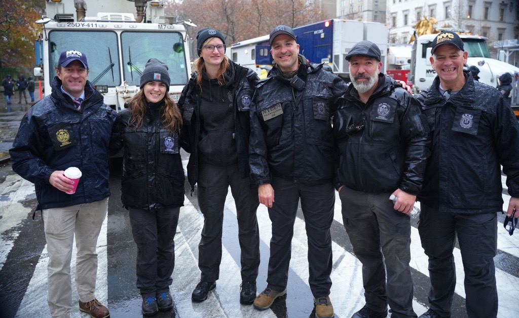 Five NYCEM Employees stand next to one another in uniform at the 2024 Thanksgiving Day Parade
                                           