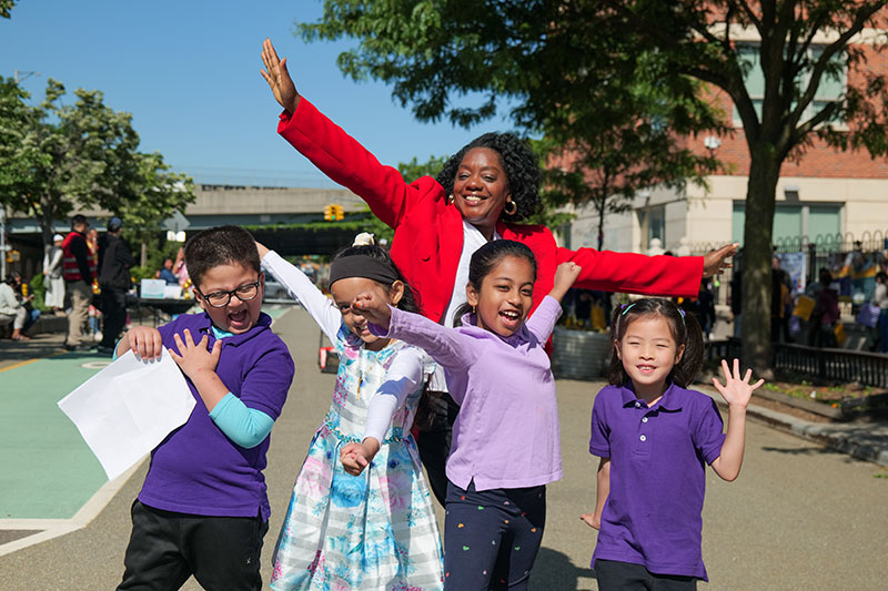 Commissioner Sideya Sherman pose with children at the 529 Market Day event.