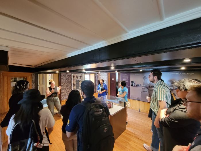 SYEP participants stand inside the Alice Austen House learning more about LGBTQ+ history.