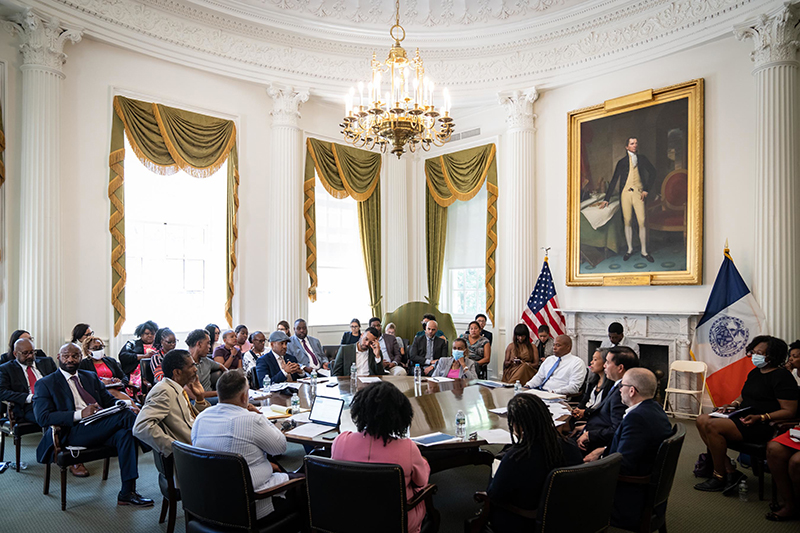 Mayor Eric Adams, Commissioner Sideya Sherman, the Mayor's Office of Equity, Commissioner Kevin Kim, the NYC Dept. of Small Business Services, sitting at a roundtable discussion at City Hall.