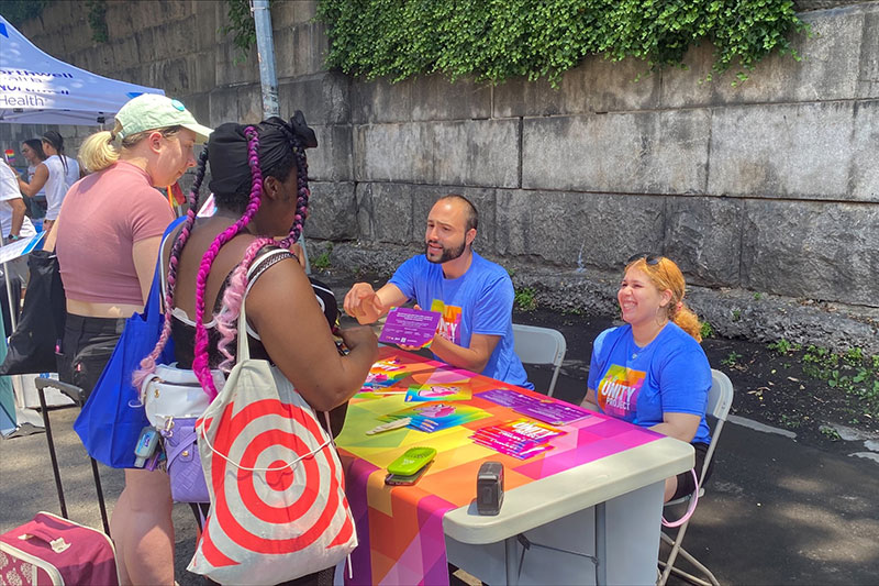 MOE staff Aura Jimenez and Ronald Porcelli sharing information about free resources for the LGBTQIA community.