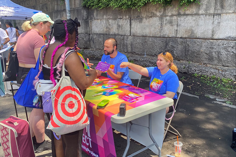 MOE staff Aura Jimenez and Ronald Porcelli sharing information about free resources for the LGBTQIA community.