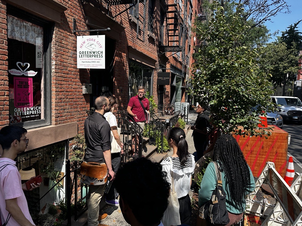 SYEP participants stand on Christopher Street Listening to NYC LGBT Historic Sites Project tour guide Ken Lustbader recall its rich history with the LGBTQ community.