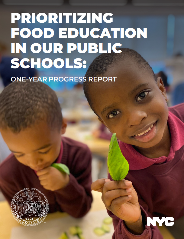 Two students holding up leaves and participating in food education 
                                           