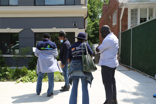 4 people split into 2 groups with their back facing toward us