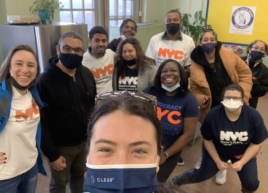 11 staff members wearing t-shirts that say NYC Mayor's Public Engagement Unit and DemocracyNYC.