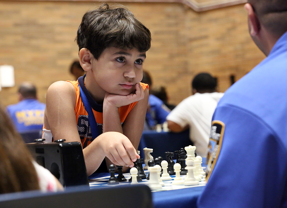 Young adults from all five boroughs connect with NYPD cops at a chess tournament