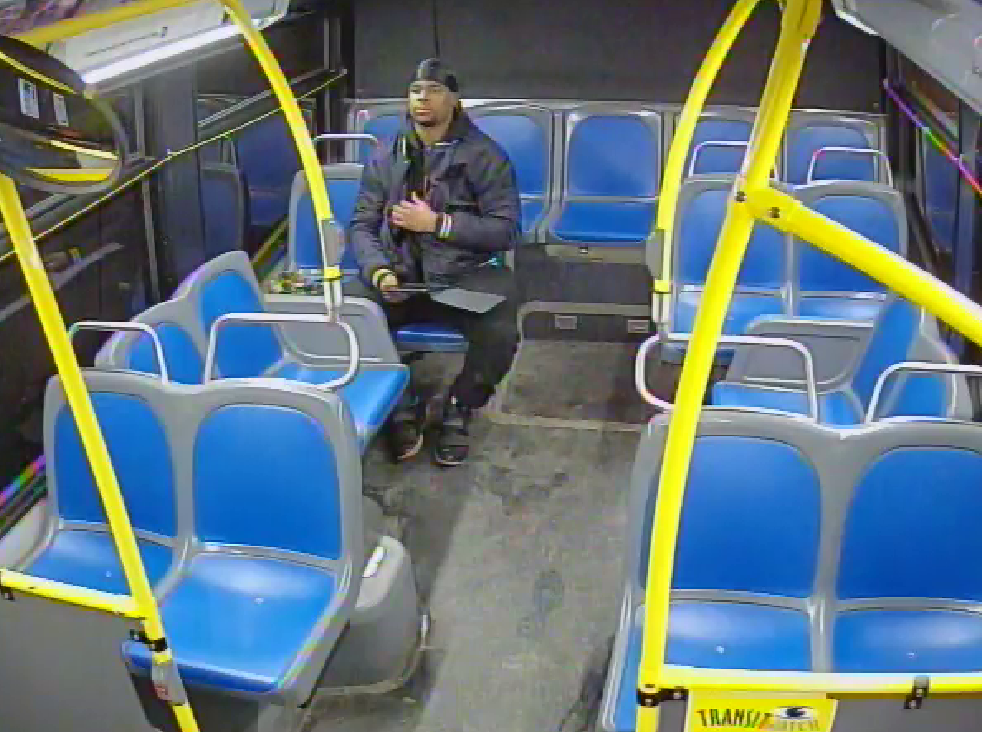 Surveillance footage of suspect on bus with iPad