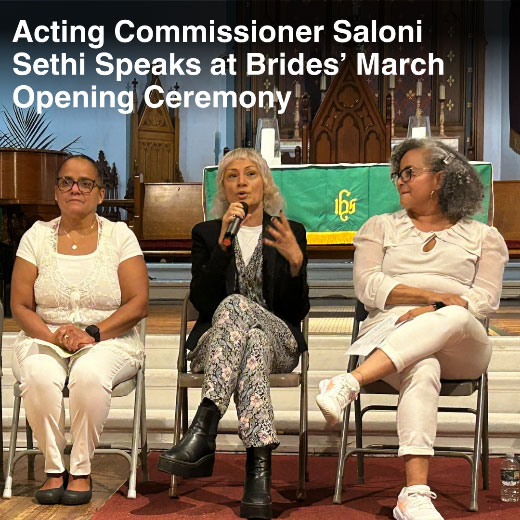 Commissioner Sethi (Center) sits with two Brides' March organizers and gives opening remarks to start the march.