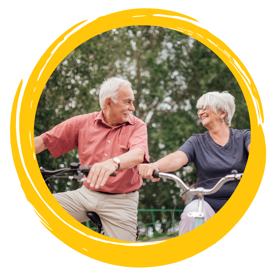 Photo of two people looking at each other, smiling and riding bikes