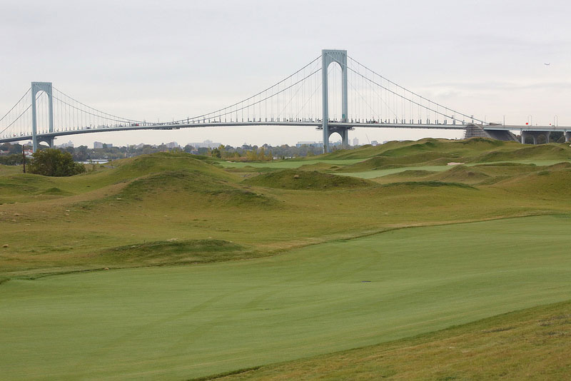 Green lawn with bridge in background