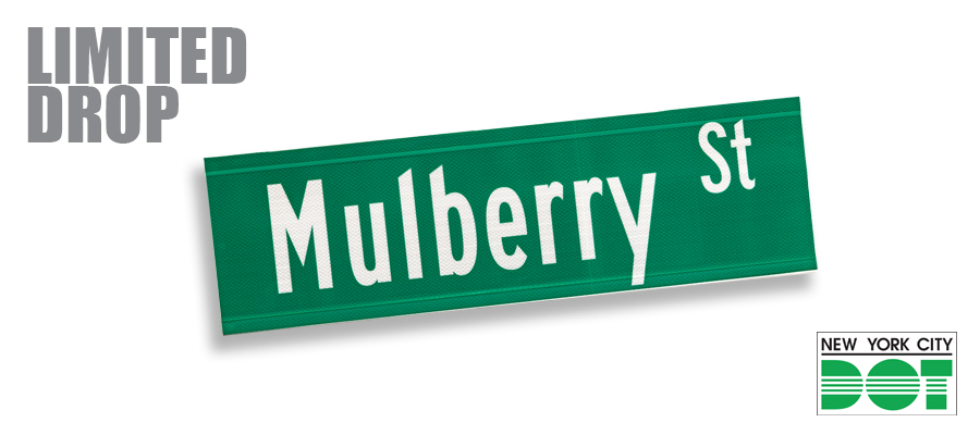 Green and white sign of Mulberry Street. A limited drop from N Y C D O T.