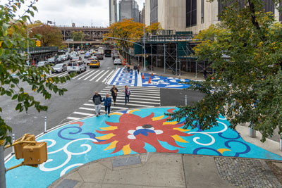 Colorful murals are painted on curb extensions in Lower Manhattan. The designs are based on various patterns from traditional Chinese culture such as clothing, porcelain, and architecture. 