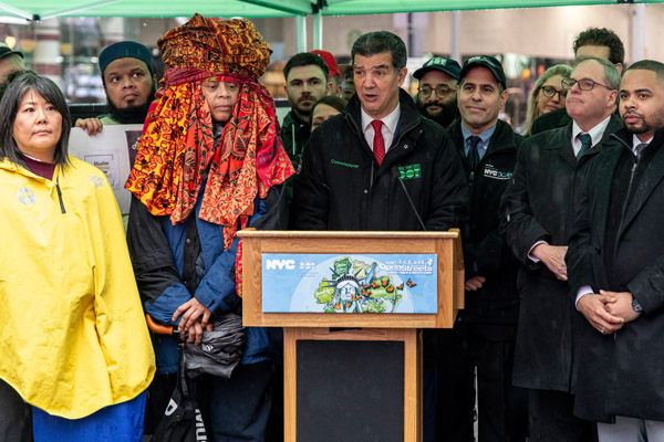 Commissioner Rodriguez stands behind a podium during a press conference to announce the partners involved in the 2024 Car-Free Earth Day event