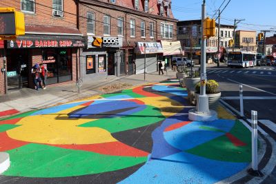 Public Access asphalt art mural by Mollie Hosmer-Dillard in partnership with On Your Mark, located on Victory Boulevard and Corson Avenue on Staten Island.