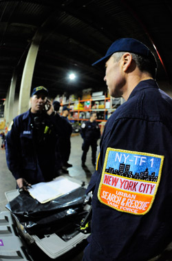 Capt. James Davolio and Lt. Paul Rogers prepare to leave for Haiti as part of the FDNY's Urban Search and Rescue team. Thirty-six firefighters, four paramedics and two FDNY physicians were deployed with the team on Jan. 14.