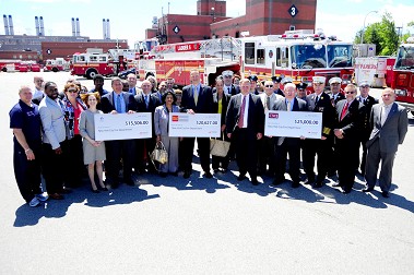 Representatives from Fireman's Fund, Taylor and Taylor, Wells Fargo and CMJ Underwriters stand with members of the FDNY at the Fire Academy.